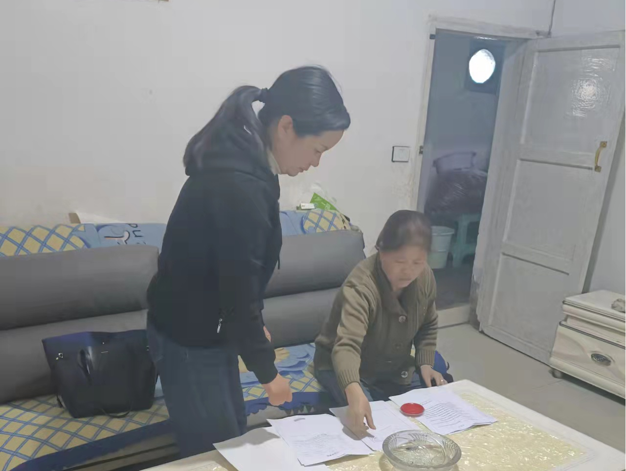 图为 息烽县司法局公证处工作人员到群众家中为其办理公证.png